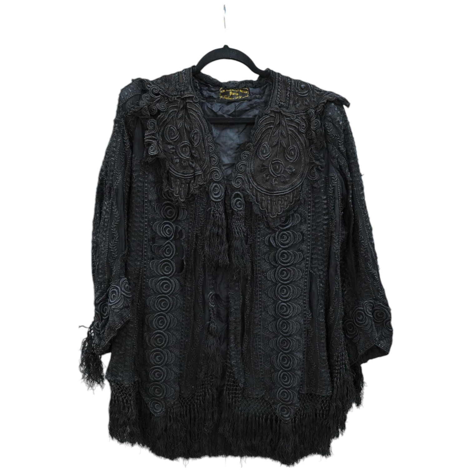 An Edwardian black chiffon and lace evening jacket with tassel decoration to the front and back, edged with tasselled fringing to the edge of sleeves and bottom, 85cm long from nape of neck at the back to bottom of tasse